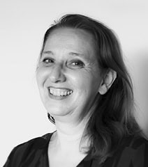 Portrait professionnel en noir et blanc d'une femme souriante, représentant la marque Urb1n.