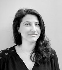 Portrait d'une femme élégante et confiante, souriant légèrement, avec des cheveux longs et ondulés,.
